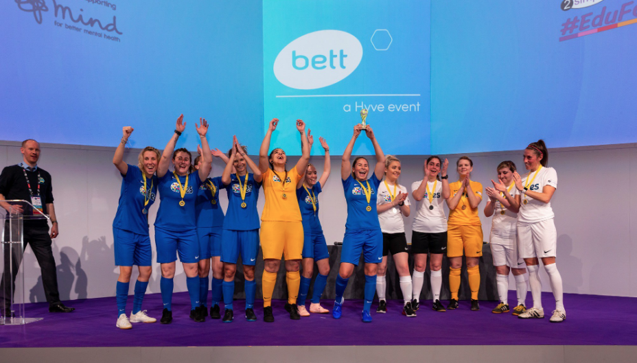 Both female teams (sponsored by TES) on the main stage of the Bett arena for #EduFootyAid at Bett by 2Simple Ltd